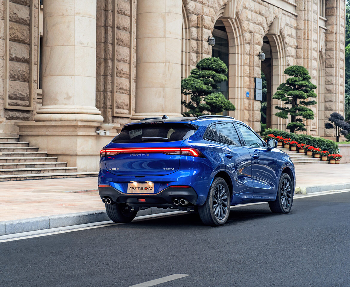 Elegant blue Forthing T5 EVO against historical building